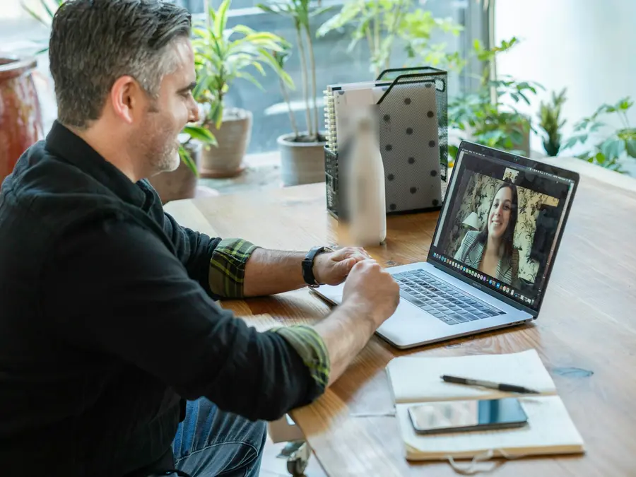 Professional on a video call with a client from a laptop