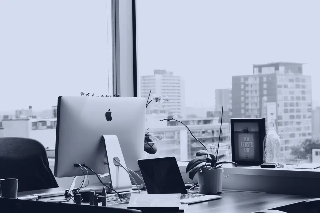 Workstation with a computer by an office window